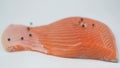 Fresh salmon fillet decorated with black pepper, pink Himalayan salt and lemon on a white background