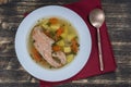 Fresh salmon fish soup with carrots and potatoes in a white plate, close up Royalty Free Stock Photo