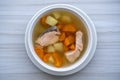 Fresh salmon fish soup with carrots, potatoes and onions in a white plate, close up. Tasty dinner consists of a fish soup with Royalty Free Stock Photo