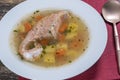 Fresh salmon fish soup with carrots and potatoes in a white plate, close up Royalty Free Stock Photo