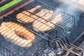 Fresh salmon fish steaks on the grill. the concept of cooking on the street, backyard Royalty Free Stock Photo
