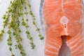 Fresh salmon with fresh thyme on a white board Royalty Free Stock Photo