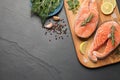 Fresh salmon and ingredients for marinade on black table, flat lay. Space for text Royalty Free Stock Photo