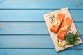 Fresh salmon and ingredients for marinade on light blue wooden table, top view. Space for text Royalty Free Stock Photo