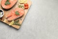 Fresh salmon and ingredients for marinade on light grey table, top view. Space for text Royalty Free Stock Photo