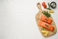 Fresh salmon and ingredients for marinade on white wooden table, top view. Space for text Royalty Free Stock Photo