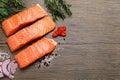 Fresh salmon and ingredients for marinade on wooden table, flat lay. Space for text Royalty Free Stock Photo
