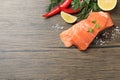 Fresh salmon and ingredients for marinade on wooden table, flat lay. Space for text Royalty Free Stock Photo