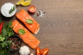 Fresh salmon and ingredients for marinade on wooden table, flat lay. Space for text Royalty Free Stock Photo