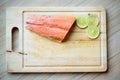 Fresh salmon, lemon slice on wood chopping board. image for background Royalty Free Stock Photo