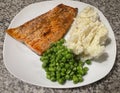 Fresh Salmon, mashed Potato and green Peas on a white plate Royalty Free Stock Photo