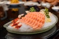 Fresh salmon sashimi, lemon slices and greenery on ice Royalty Free Stock Photo