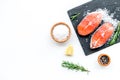 Fresh salmon steak with spices, rosemary, lemon for cooking healthy food on white background top view mock-up Royalty Free Stock Photo