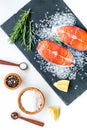 Fresh salmon steak with spices, rosemary, lemon for cooking healthy food on white background top view Royalty Free Stock Photo