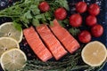 fresh salmon steakes with greenery, lemon and cherry tomatoes