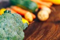 fresh salubrious colourful vegetables on wooden background, broccoli in focus, potatoes, carrots, zucchini unfocused, selected