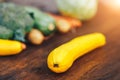 Fresh salubrious colourful vegetables on wooden background, squash in focus, potatoes, carrots, broccoli, zucchini unfocused, Royalty Free Stock Photo