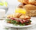 Fresh sandwich-croissant with ham, arugula, cucumber and cheese Royalty Free Stock Photo