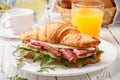 Fresh sandwich-croissant with ham, arugula, cucumber and cheese Royalty Free Stock Photo