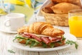 Fresh sandwich-croissant with ham, arugula, cucumber and cheese Royalty Free Stock Photo