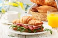 Fresh sandwich-croissant with ham, arugula, cucumber and cheese Royalty Free Stock Photo