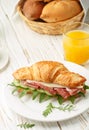 Fresh sandwich-croissant with ham, arugula, cucumber and cheese Royalty Free Stock Photo