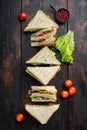 Fresh sandwiches with ingredients, on dark wooden background, top view Royalty Free Stock Photo