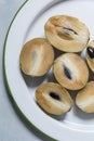 Fresh Sapodilla fruit carving on the plate. Royalty Free Stock Photo