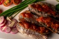 Fresh sardines with tomato sauce and other vegetables