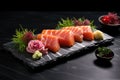 fresh sashimi slices on black slate plate with wasabi