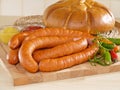 Fresh sausage on a cutting board with bread Royalty Free Stock Photo