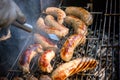 Fresh sausage and hot dogs grilling outdoors on a gas barbecue g