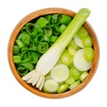 Fresh scallion bulb and sliced scallions, in a wooden bowl Royalty Free Stock Photo