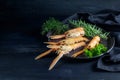 Fresh scampi, also called Norway Lobster or langoustine, with herbs on a plate on a dark blue wooden background, expensive seafood Royalty Free Stock Photo