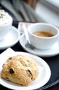 A fresh scone with raisins with coffee