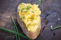 Fresh scrambled eggs with chives on crispy bread in a clay bowl on a wooden table Royalty Free Stock Photo