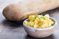 Fresh scrambled eggs with chives in a clay bowl on a wooden table Royalty Free Stock Photo