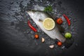 Fresh sea bass fish for cooking with herbs and spices Royalty Free Stock Photo