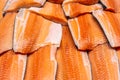 Fresh seafood on crushed ice at fish market. Raw salmon fillet on display counter at store. Fish filleting bacground Royalty Free Stock Photo