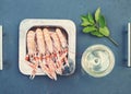 Fresh seafood metal plate on stone table. Snack, appetizer. Shrimps prawns and glass of white wine. Top view with copy space Royalty Free Stock Photo