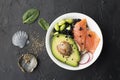 Fresh seafood recipe. Salmon gravlax poke bowl with fresh prawn, brown rice, cucumber, pickled sweet onion, radish, soy