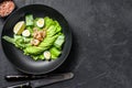 Fresh seafood salad with grilled shrimps prawns, egg, avocado and cucumber in a plate. Black background. top view. Copy Royalty Free Stock Photo