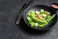 Fresh seafood salad with grilled shrimps prawns, egg, avocado and cucumber in a plate. Black background. top view. Copy Royalty Free Stock Photo