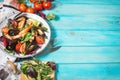 Fresh seafood salad, mussels, shrimp, fresh vegetables and herbs on blue wooden table Royalty Free Stock Photo