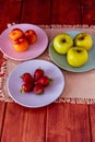 Fresh seasonal fruits and nuts in terracotta pots and colored ceramic dishes