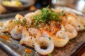 Fresh Seasoned Shrimp and Calamari Seafood Dish with Herbs and Spices on a Plate in a Rustic Restaurant Setting