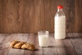 Fresh seedy bread and milk on wooden background