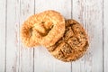 Fresh seedy breads on white wooden background