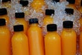 Fresh selfmade orange juice withcold ice in half litres bottles Royalty Free Stock Photo