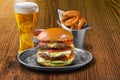 Fresh served beef burger with cold beer and onion ringsFresh served beef burger with cold beer and onion rings